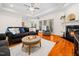 Open-concept living room with hardwood floors, a fireplace, and a view to the kitchen at 904 Hidden Jewel Ln, Wake Forest, NC 27587