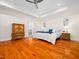 Large main bedroom featuring hardwood floors, tray ceilings and ensuite access at 904 Hidden Jewel Ln, Wake Forest, NC 27587