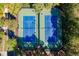 Aerial view of two well-maintained tennis courts surrounded by lush greenery, perfect for recreation at 904 Hidden Jewel Ln, Wake Forest, NC 27587