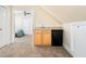 Bonus room wet bar featuring wooden cabinets, a sink, and mini fridge at 904 Hidden Jewel Ln, Wake Forest, NC 27587
