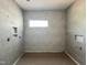 New bathroom featuring tiled walls, in-wall niche shelving, and a modern window at 95 Cherry Bark Dr, Youngsville, NC 27596