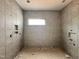 Modern bathroom showcasing elegant gray tiles and stylishly designed shower niches for storage at 95 Cherry Bark Dr, Youngsville, NC 27596