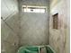 Bathroom showcases new gray tile, a built in shelf, and an updated window at 95 Cherry Bark Dr, Youngsville, NC 27596