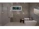 Modern bathroom showcasing a luxurious bathtub with a window view and a separate shower area at 95 Cherry Bark Dr, Youngsville, NC 27596