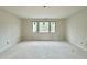 Large bedroom displays updated windows with black trim and a doorway on the left at 95 Cherry Bark Dr, Youngsville, NC 27596