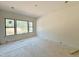 Bright bedroom featuring a large window offering views of the neighborhood at 95 Cherry Bark Dr, Youngsville, NC 27596