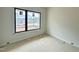 Bedroom with a large window overlooking a neighborhood street, providing natural light at 95 Cherry Bark Dr, Youngsville, NC 27596