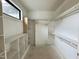 Spacious closet boasts built-in shelving, racks and an updated window for natural light at 95 Cherry Bark Dr, Youngsville, NC 27596