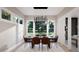 Bright dining room with modern chandelier, neutral walls and furniture with six chairs at 95 Cherry Bark Dr, Youngsville, NC 27596