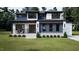 Beautifully designed modern home with a stone facade, sleek lines, and professional landscaping showcases contemporary style at 95 Cherry Bark Dr, Youngsville, NC 27596
