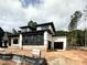 Contemporary home with black and white facade, showcasing its unique architectural design and garage at 95 Cherry Bark Dr, Youngsville, NC 27596