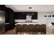 Modern kitchen features an island with bar stool seating, stainless appliances, and sleek cabinetry at 95 Cherry Bark Dr, Youngsville, NC 27596