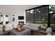Inviting living room with a fireplace, modern furnishings, and a scenic outdoor view at 95 Cherry Bark Dr, Youngsville, NC 27596
