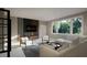 Bright living room with large windows, comfortable seating, and a chic entertainment center at 95 Cherry Bark Dr, Youngsville, NC 27596