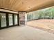 Covered patio with outdoor fireplace and backyard view provides a great place for relaxation at 95 Cherry Bark Dr, Youngsville, NC 27596