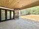 Covered patio features wood ceilings, an outdoor fireplace, and access to the backyard at 95 Cherry Bark Dr, Youngsville, NC 27596