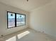 Room with neutral walls and large black frame window at 95 Cherry Bark Dr, Youngsville, NC 27596