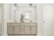 Bright bathroom with a double sink vanity, modern fixtures, and neutral color scheme at 300 Calvander Ln, Apex, NC 27539