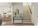 Inviting home entryway featuring hardwood floors, staircase, decor, and kitchen access at 300 Calvander Ln, Apex, NC 27539