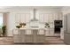 Modern kitchen with island, white countertops, stainless steel appliances, and white backsplash at 300 Calvander Ln, Apex, NC 27539