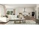 Open-concept living room featuring hardwood floors, neutral tones, and natural lighting at 300 Calvander Ln, Apex, NC 27539