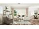 Bright, spacious living room with modern decor, natural light, and hardwood floors at 300 Calvander Ln, Apex, NC 27539