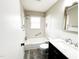 Bathroom featuring tiled shower, white subway tile, and a modern vanity with marble countertop at 1 Greenfield Ct, Durham, NC 27705