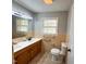 Bathroom featuring a dual sink vanity, natural light, and neutral accents at 1 Greenfield Ct, Durham, NC 27705