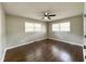 Bedroom features two windows for natural light and sleek dark hardwood floors at 1 Greenfield Ct, Durham, NC 27705