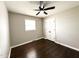 Bedroom with hardwood floors, neutral paint, a ceiling fan, and a closet, creating a cozy and inviting space at 1 Greenfield Ct, Durham, NC 27705