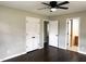 Bright bedroom features hardwood floors and doors to other rooms in the house at 1 Greenfield Ct, Durham, NC 27705