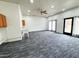 Expansive bonus room with neutral carpet, bright lighting, and a door to the outside at 1 Greenfield Ct, Durham, NC 27705