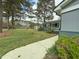 Landscaped front yard with vibrant flower bushes, mature trees, and a well-maintained lawn at 1 Greenfield Ct, Durham, NC 27705