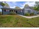 Charming single-story home with gray exterior, black shutters, and landscaped front yard with mature trees at 1 Greenfield Ct, Durham, NC 27705