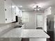 Updated kitchen featuring white cabinets, stainless steel appliances, and granite countertops at 1 Greenfield Ct, Durham, NC 27705