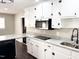 Updated kitchen with white cabinets, modern lighting, stainless appliances, and granite countertops at 1 Greenfield Ct, Durham, NC 27705