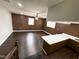 Spacious living room with wood paneled wall and bar seating at 1 Greenfield Ct, Durham, NC 27705