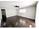 Spacious living room with hardwood floors, a ceiling fan, and neutral paint, creating a bright and airy feel at 1 Greenfield Ct, Durham, NC 27705