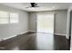Bright living area featuring hardwood floors, neutral paint, a ceiling fan, and sliding glass doors to the outside at 1 Greenfield Ct, Durham, NC 27705
