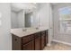 A well-lit bathroom features a double sink vanity with dark wood cabinets at 102 Bella Pl, Holly Springs, NC 27540