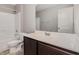 Bright bathroom featuring a shower-tub combo, toilet, vanity with sink and a mirror at 102 Bella Pl, Holly Springs, NC 27540