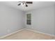 A bright carpeted bedroom is illuminated by natural light from a window at 102 Bella Pl, Holly Springs, NC 27540