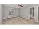 A carpeted bedroom with a ceiling fan and natural light streaming from the window at 102 Bella Pl, Holly Springs, NC 27540