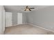 This carpeted bedroom includes a ceiling fan and neutral colored walls at 102 Bella Pl, Holly Springs, NC 27540