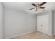 This carpeted bedroom includes a ceiling fan and built in closet at 102 Bella Pl, Holly Springs, NC 27540