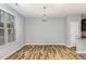 A dining room area features hardwood floors, modern lighting and neutral gray walls at 102 Bella Pl, Holly Springs, NC 27540