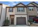 Charming townhome featuring a one-car garage, shutters, and a combination of siding and brick at 102 Bella Pl, Holly Springs, NC 27540