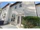 Low angle view of home exterior showing wood siding, windows and sliding glass door at 102 Bella Pl, Holly Springs, NC 27540