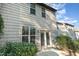 Exterior angle view showing windows and sliding glass door onto the back of the home at 102 Bella Pl, Holly Springs, NC 27540