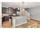 Modern kitchen featuring a large island, stainless steel appliances, and dark wood cabinets at 102 Bella Pl, Holly Springs, NC 27540